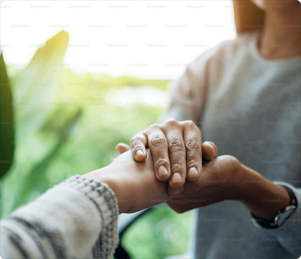 Financial advisor holding client's hands in a supportive gesture